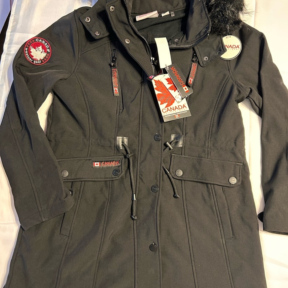 Canada Weather Gear black winter coat with detail patches and warm pockets.
